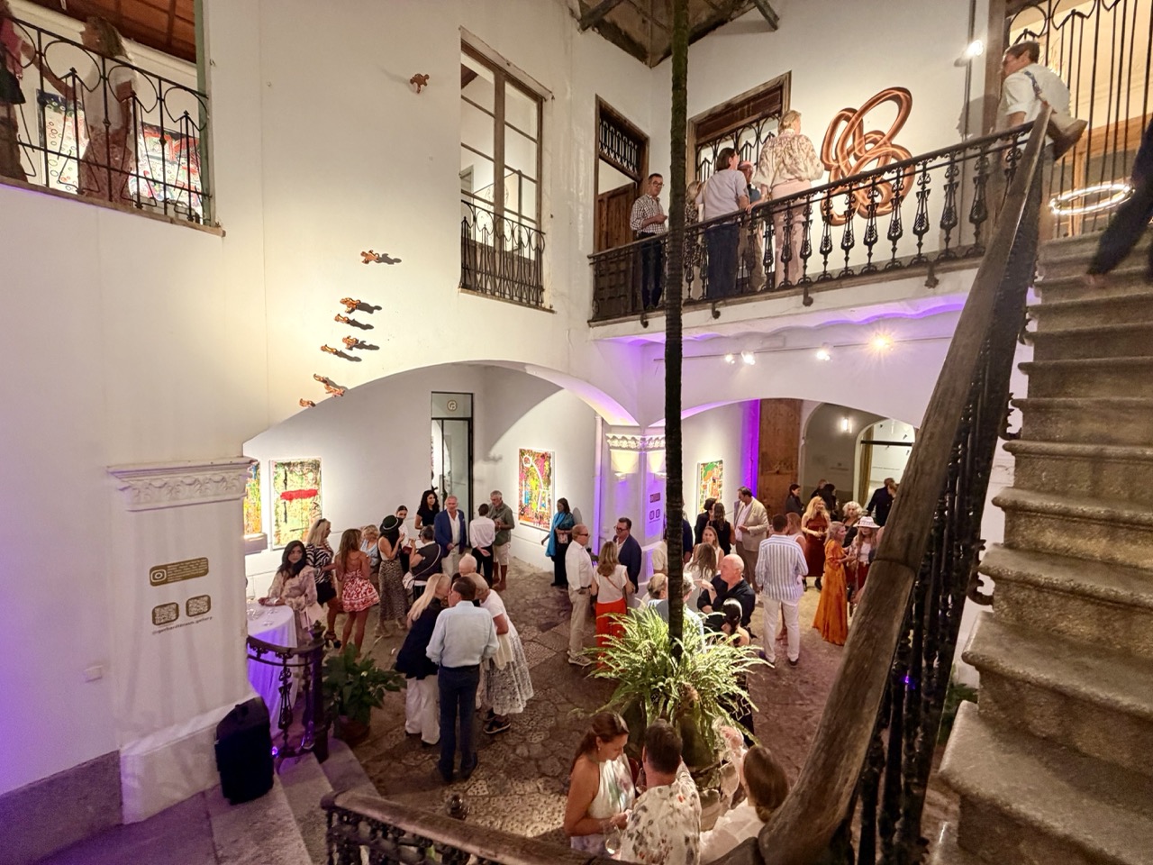 Colourful contemporary painting and visitors on a mezzanine at Gerhardt Braun Gallery during Nit de l'Art Palma