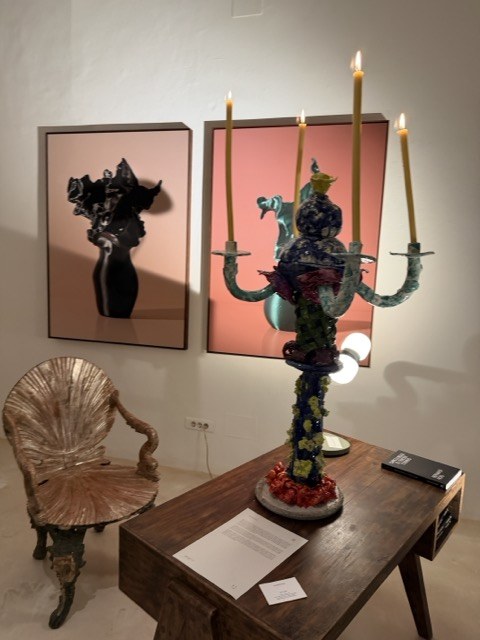Ceramic candelabra sculpture beside framed works at a Palma gallery