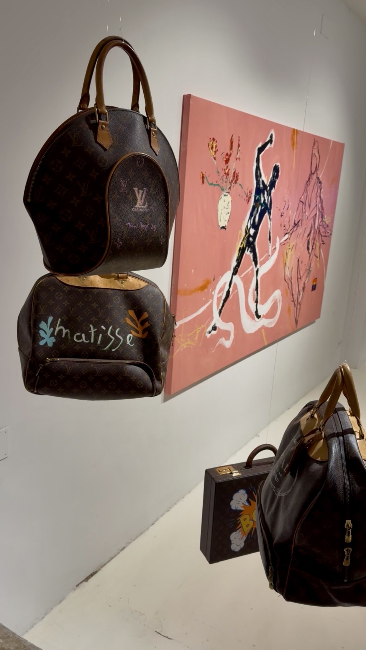 Louis Vuitton bag hand-painted in a Matisse style beside a contemporary canvas at Nit de l'Art Palma