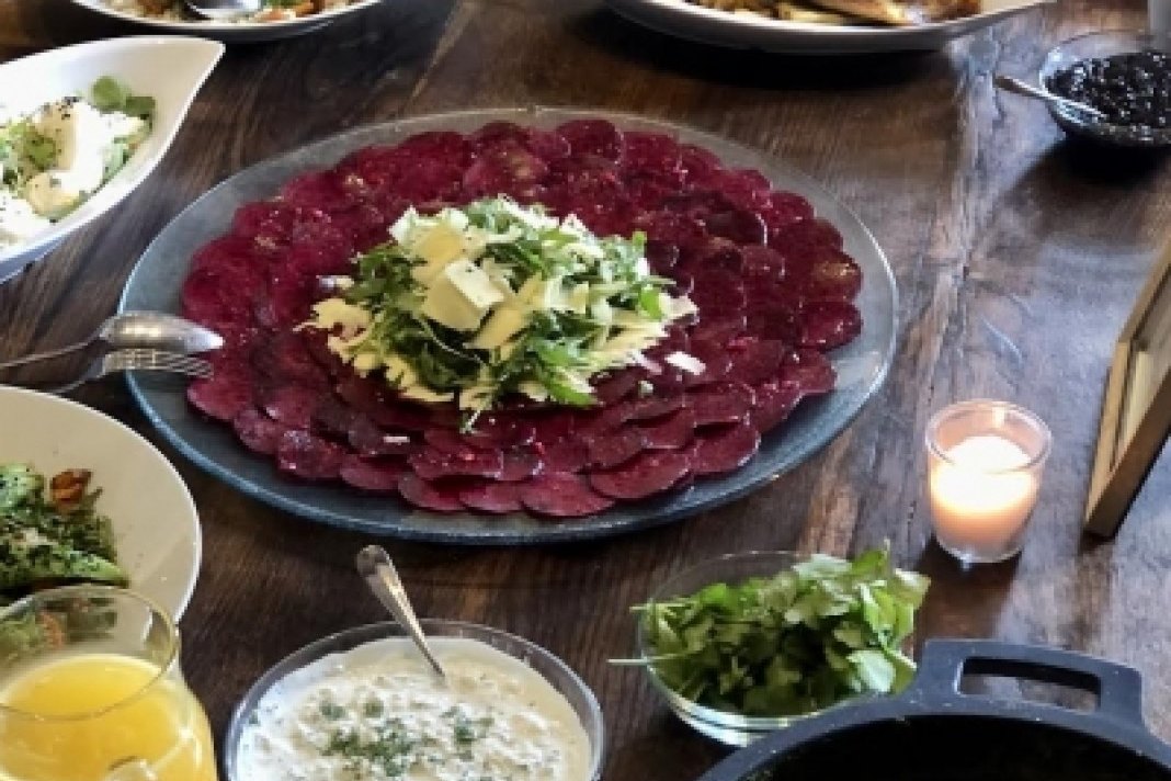 Healthy shared lunch on a wooden table at Ananda Mallorca yoga retreat