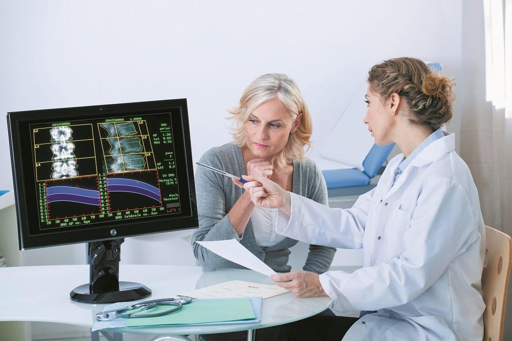 Woman discussing her bone density scan results with a doctor