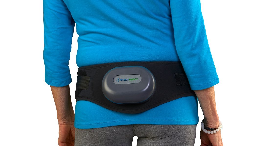 Woman wearing the Osteoboost vibration belt around her hips