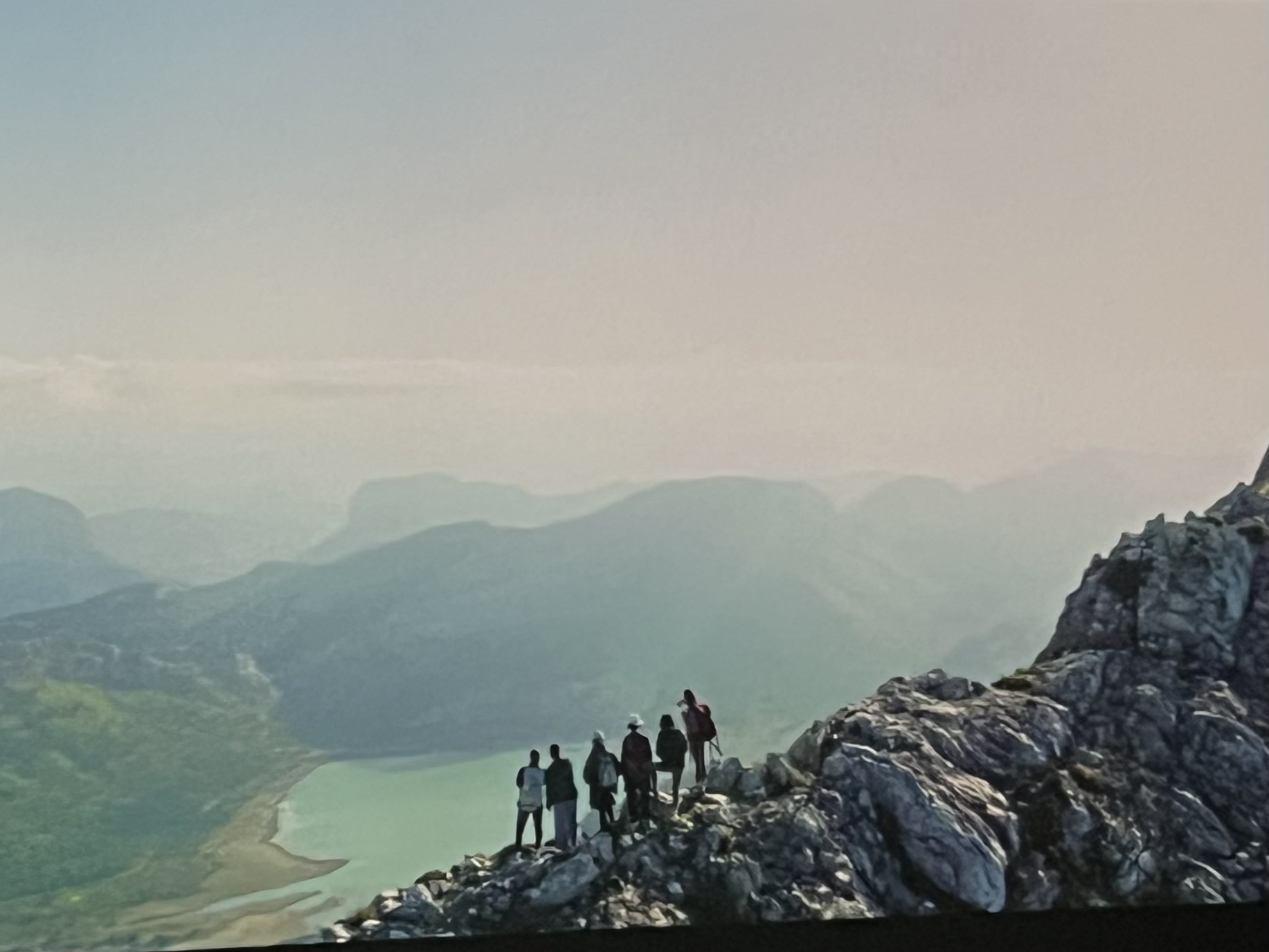 Group of women standing on a rocky ridge above a reservoir in Mallorca’s Serra de Tramuntana, a still from the Sacar Pecho breast cancer documentary