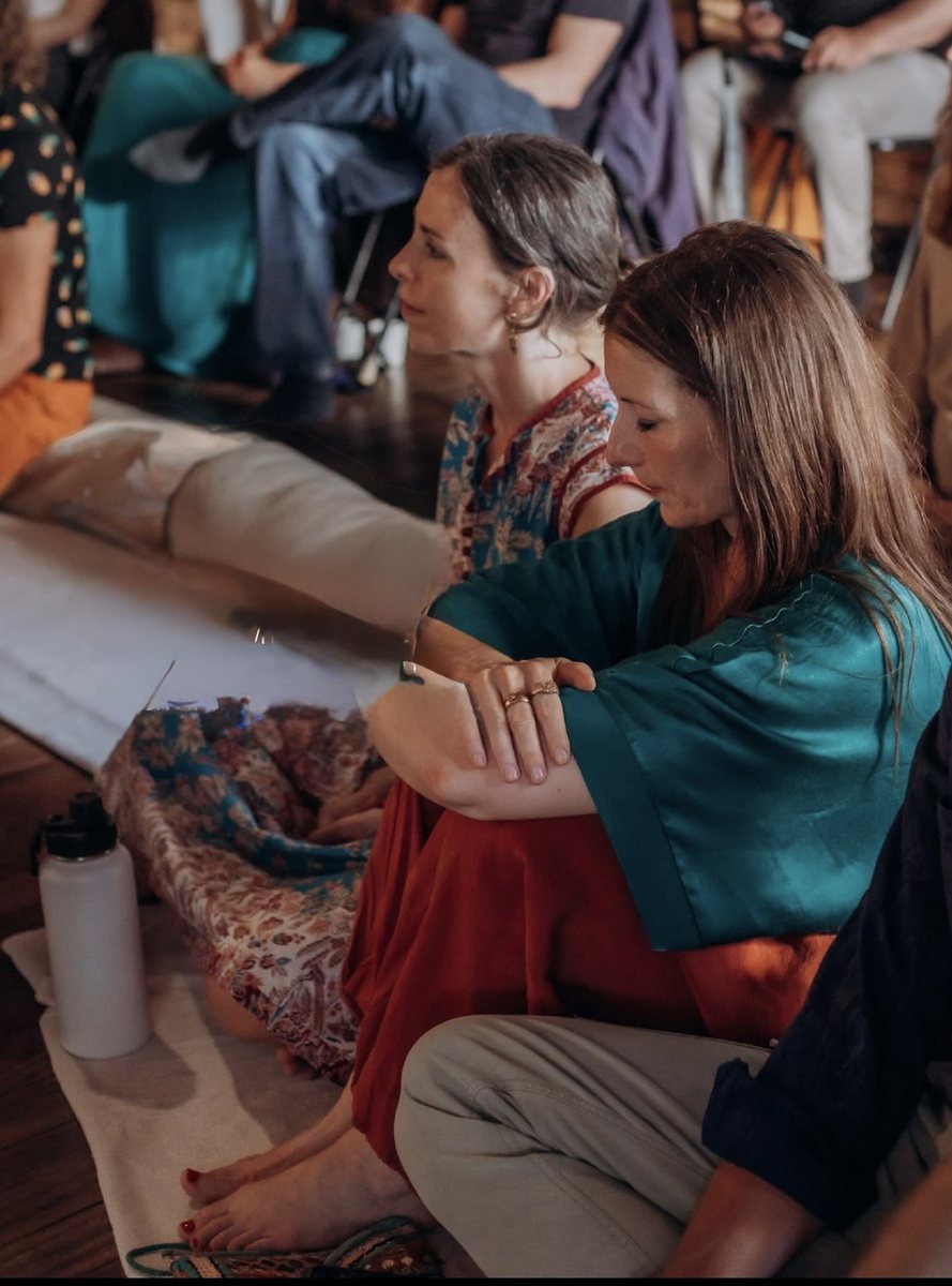 Women sitting together and listening during a wellbeing session at Sadhana Works, Palma