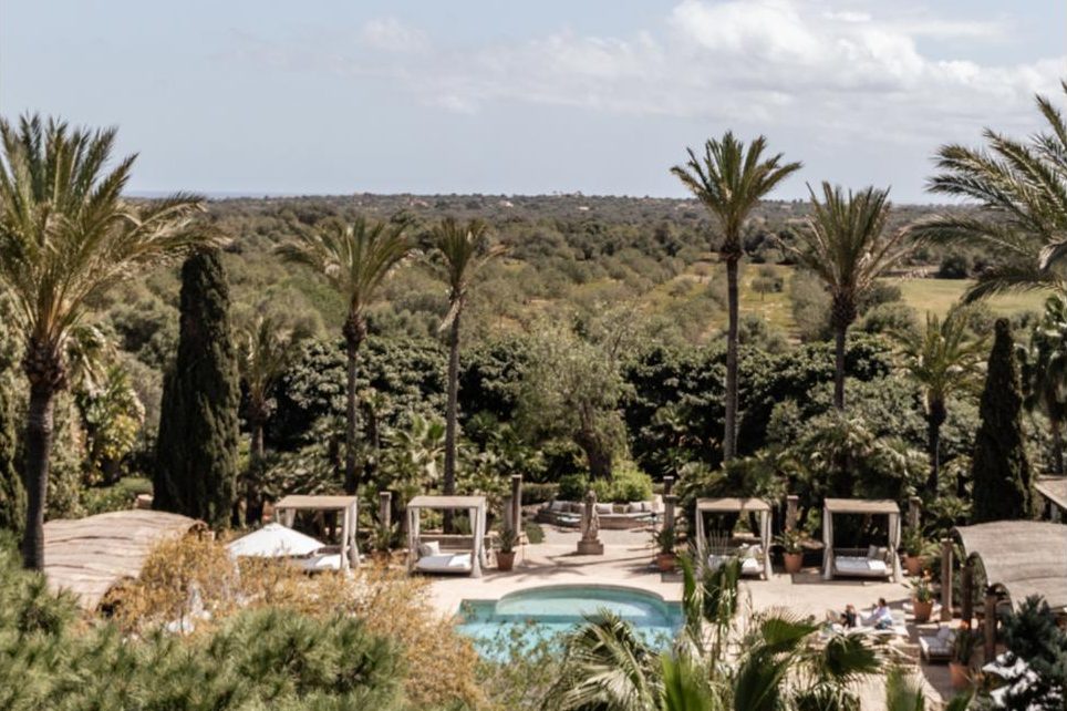 Palm gardens and pool at Cal Reiet near Santanyí, Unplug yoga retreat by Sukha, Mallorca