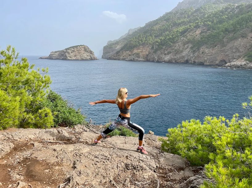 Yoga pose on the rocks above the sea near Port de Sóller, Mallorca